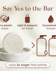 Round white shampoo bar resting on a marble dish with a soft beige background and the caption Lasts 2x longer than bottles