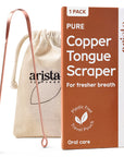 Copper tongue scraper beside a beige drawstring bag and orange packaging labeled Pure Copper Tongue Scraper