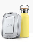 Yellow insulated bottle with cork cap and metal handle beside a silver lunch tin.