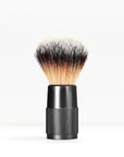 Shaving brush with light bristles and black knurled handle on white background.