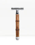 Bamboo safety razor with glossy brown bamboo handle and polished chrome head on a white backdrop