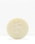 Partial view of a pale shaving bar with decorative geometric cutouts against a white background