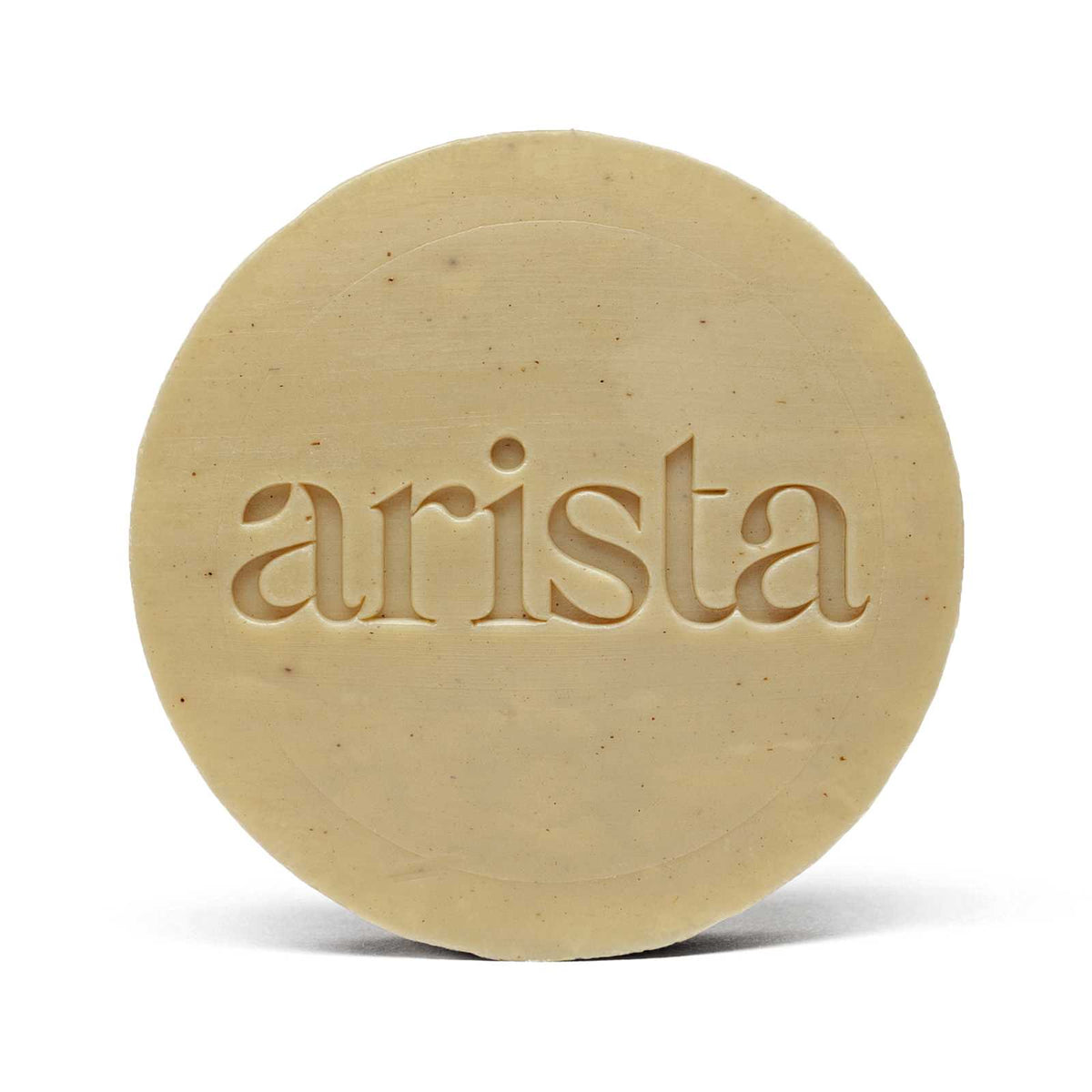 Beige circular shampoo bar for oily hair embossed with arista atop its orange packaging box