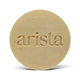 Beige circular shampoo bar for oily hair embossed with arista atop its orange packaging box