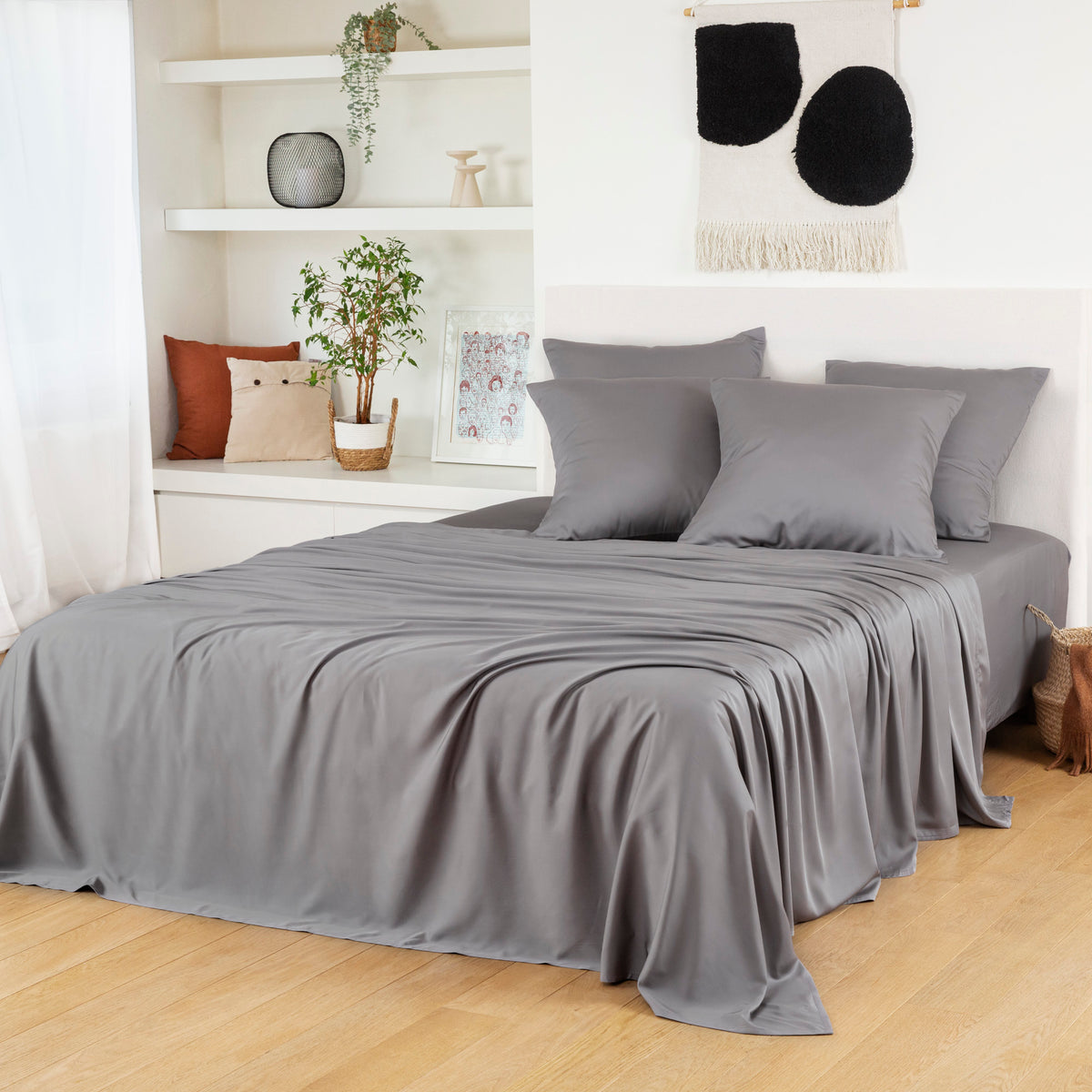 Bamboo Flat Sheets in soft grey cover a bed with matching pillowcases in a serene room.