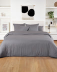 Light gray bamboo duvet cover on a white bed in a bright minimalist bedroom