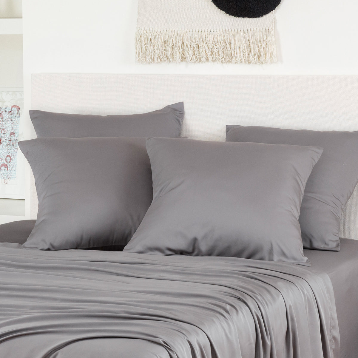 Gray bamboo pillowcases two-pack on a bed with light neutral bedding.