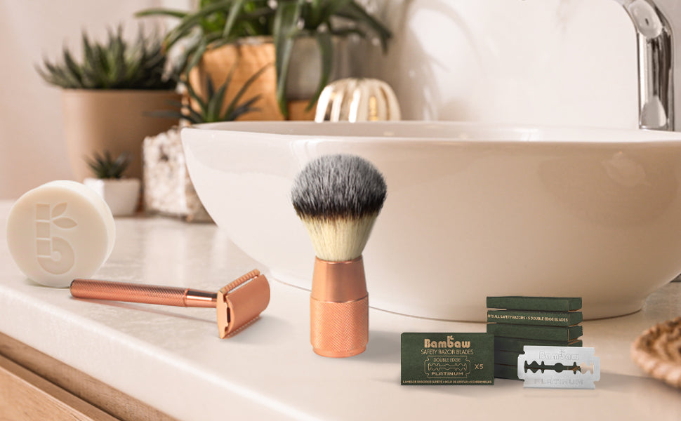 Shaving setup on bathroom counter with copper razor, fluffy brush, and blade boxes