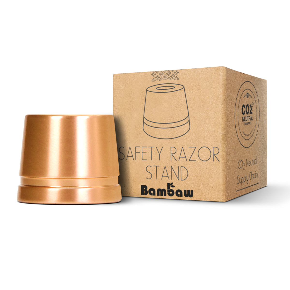 Copper safety razor stand beside a Bambaw cardboard box with bamboo graphics