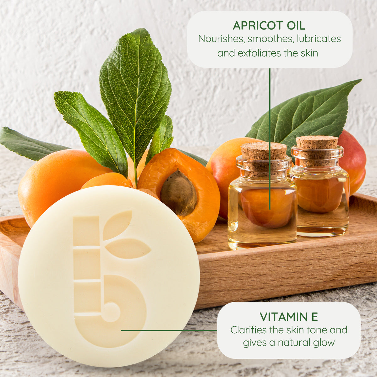 Apricot oil scene with fresh apricots leaves and two corked glass bottles