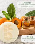 Apricot oil scene with fresh apricots leaves and two corked glass bottles