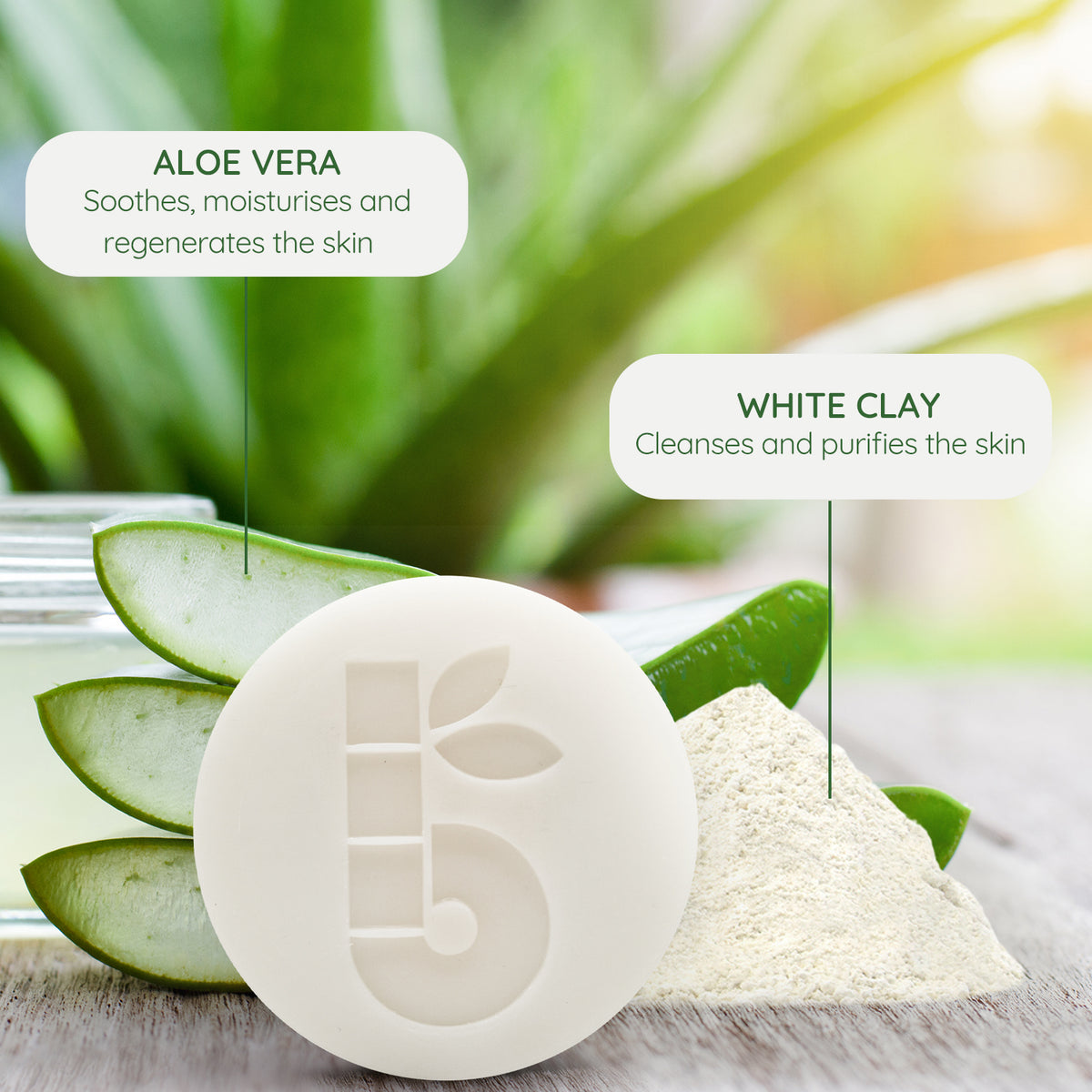 Shaving bar with aloe vera and white clay ingredient labels on a green blurred backdrop
