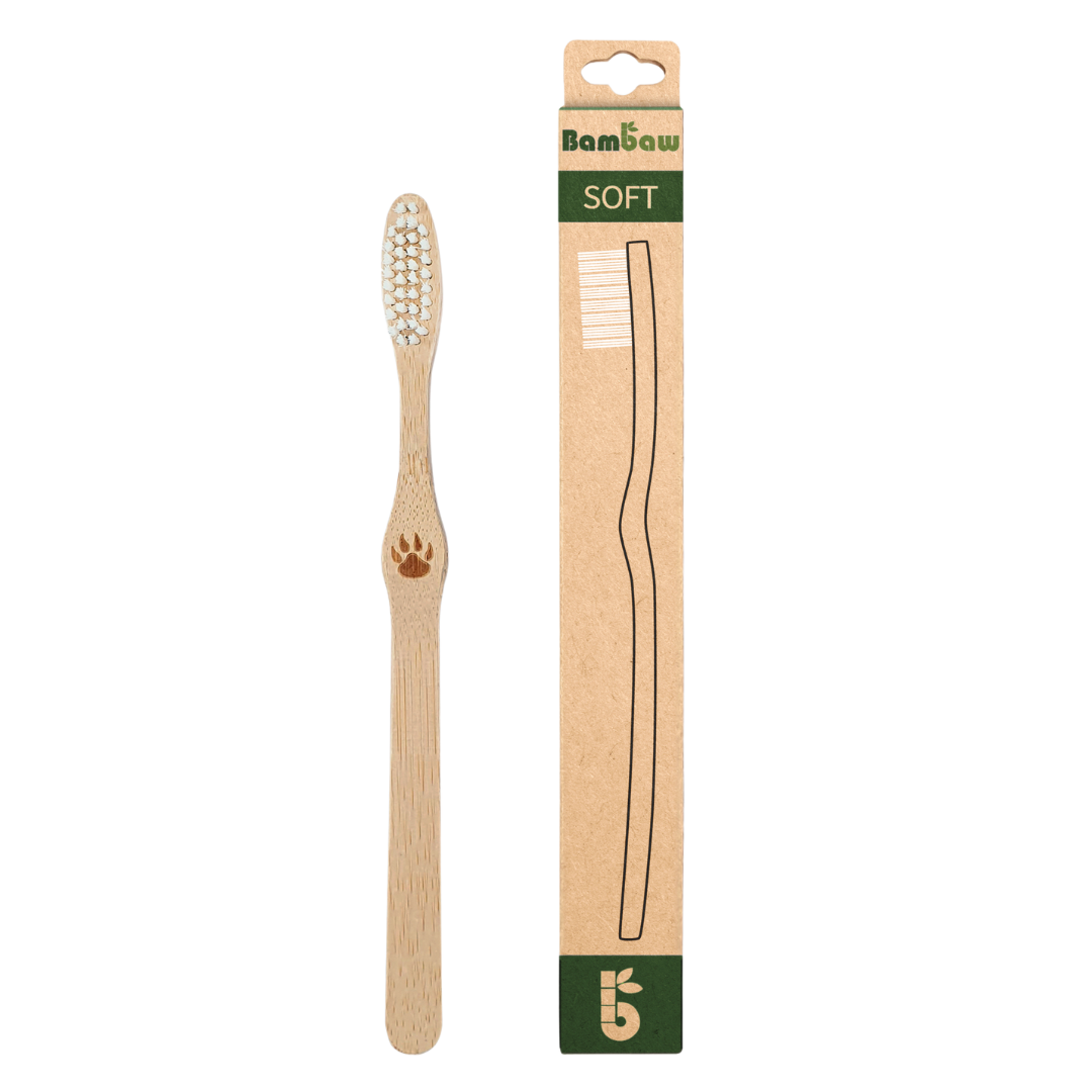 Bamboo toothbrush with soft bristles shown beside its cardboard packaging labeled SOFT