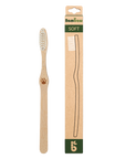Bamboo toothbrush with soft bristles shown beside its cardboard packaging labeled SOFT