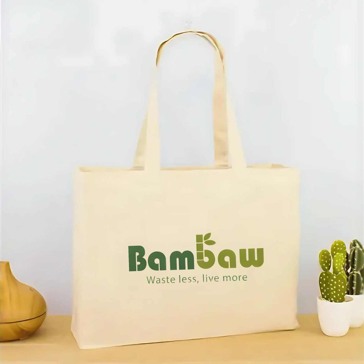 Beige 100% organic cotton tote bag with two handles and a green Bambaw logo