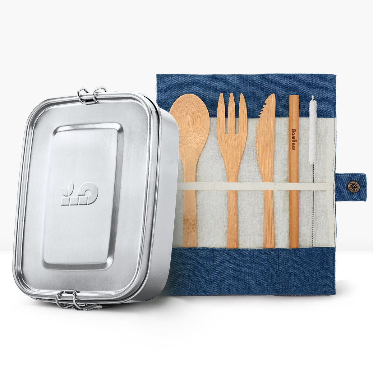 Metal lunch tin next to a teal fabric roll holding wooden cutlery for the two piece back to school bundle