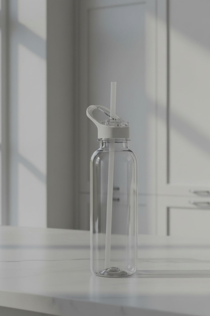 Clear water bottle with a white cap on a light surface with a neutral background