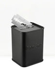 Black metal razor blade holder with blades on a white background