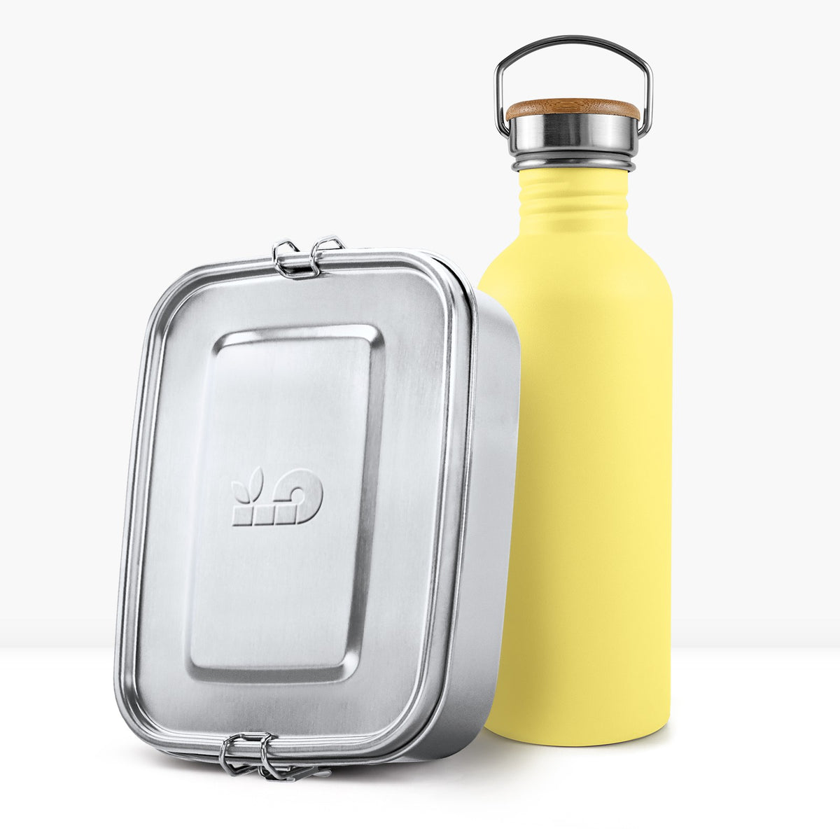 Yellow non insulated bottle with a wooden lid handle beside a silver lunch tin.