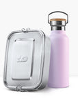 Close up of a lavender insulated bottle with a wooden cork lid beside a silver lunch tin