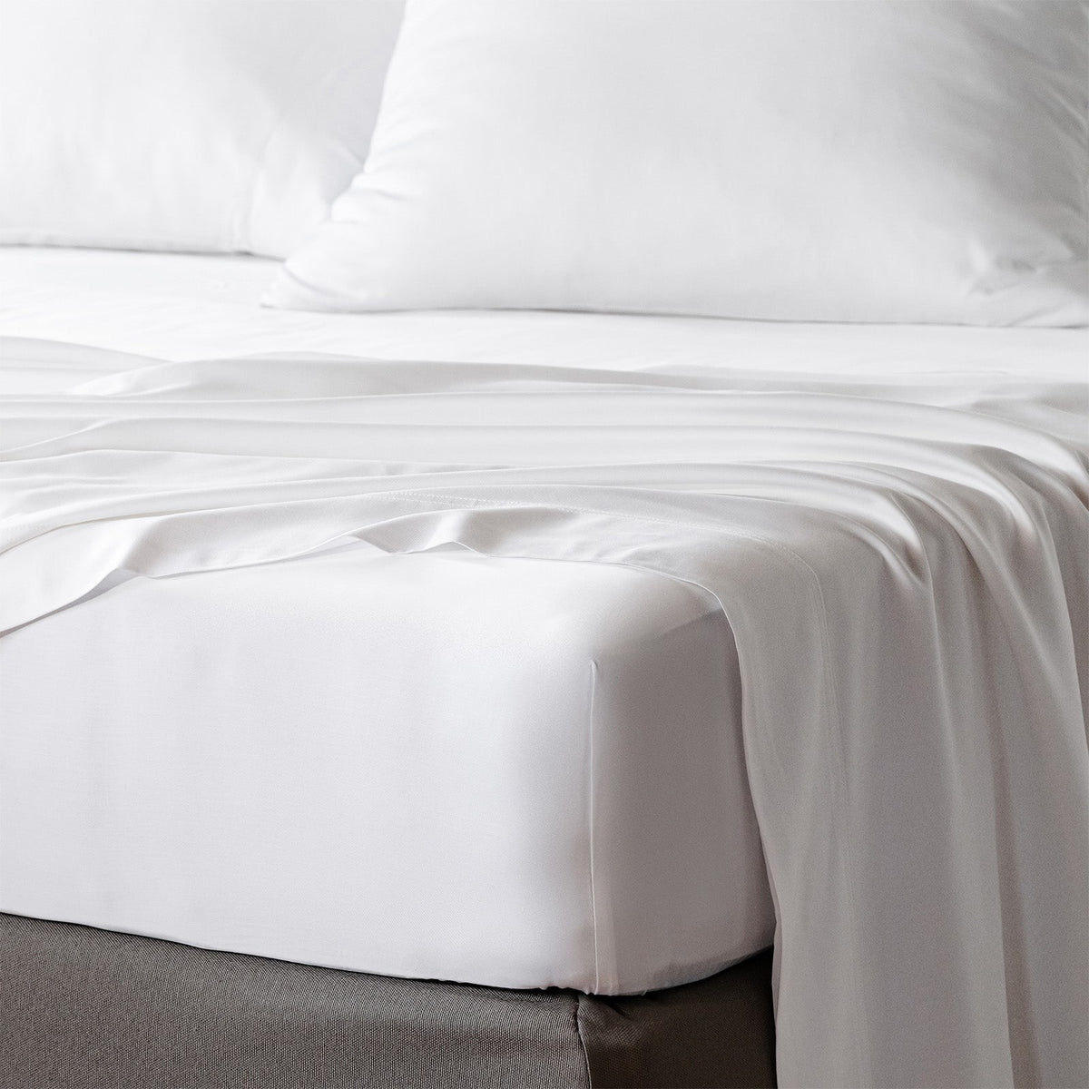bambaw cozy bamboo bed sheets close up on a bed with fitted sheets and pillows in white colour