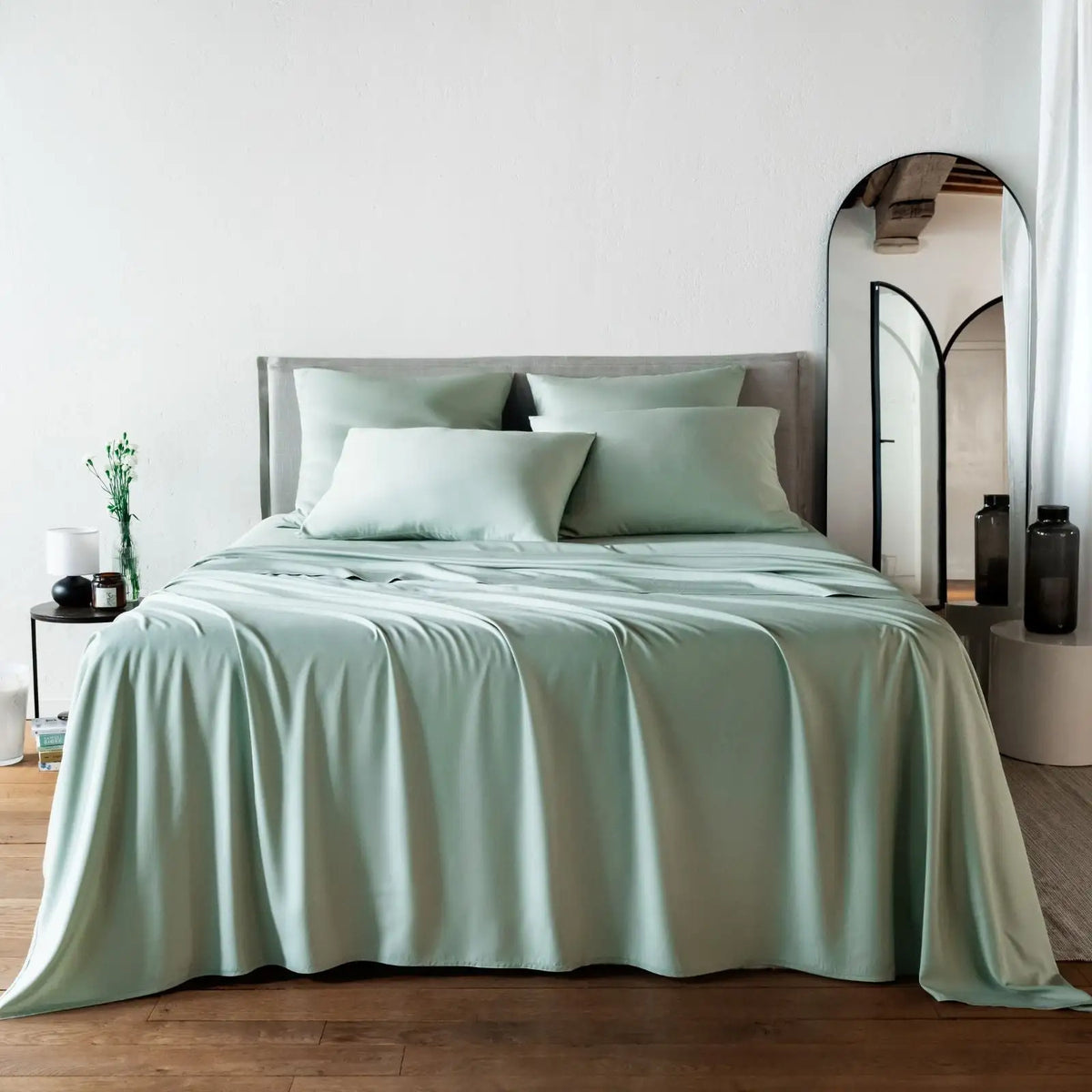 Bed with light green bambaw cozy bamboo bedding in a bedroom setting