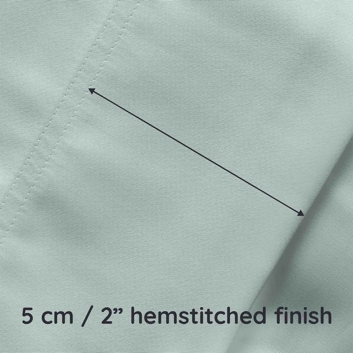 Close-up of light green bamboo fabric with a hemstitched finish and measurement text.