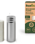 Bambaw bio based floss packaging box with a metal floss dispenser beside a white floss spool