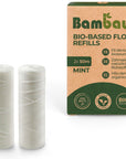 Three white PLA corn starch floss spools beside a tan and green packaging box