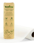 Bambaw Reusable Bamboo Paper Towels packaging stands upright beside a white paper towel roll on a white backdrop.
