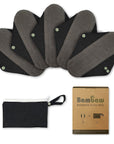 Five grey and black reusable sanitary pads arranged in a fan with a box nearby