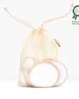 Beige reusable makeup remover pads in a mesh drawstring bag against a white background with an awards badge