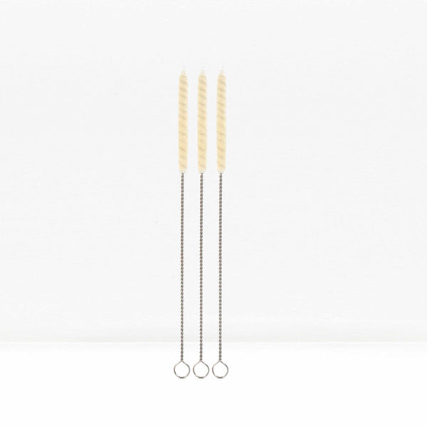Three cotton straw cleaning brushes with twisted metal handles standing upright against a white background.