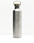 Brushed stainless steel insulated bottle with wooden cap and curved metal carrying handle