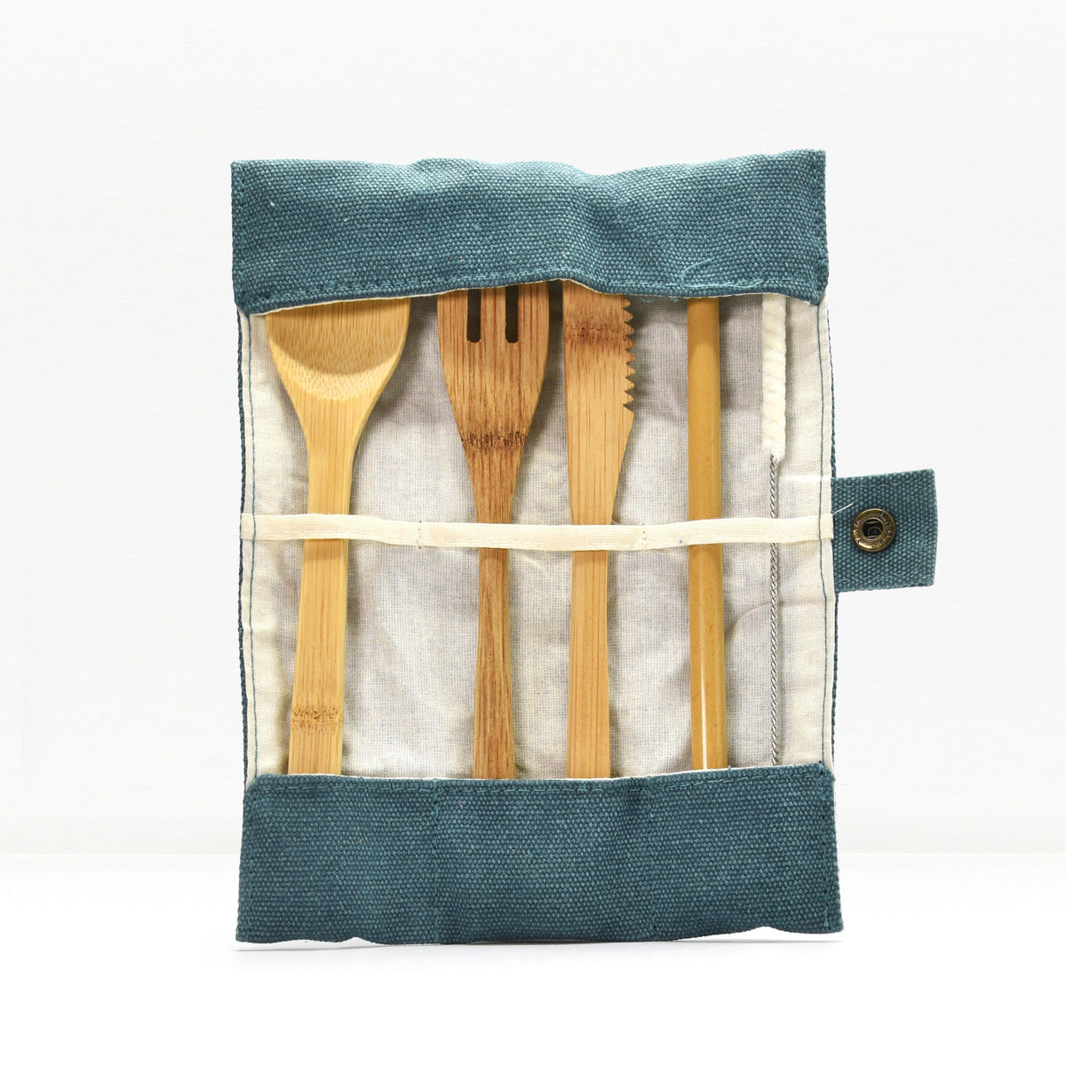 Top view of a bamboo cutlery set tucked into a blue denim roll with wooden utensils peeking out.