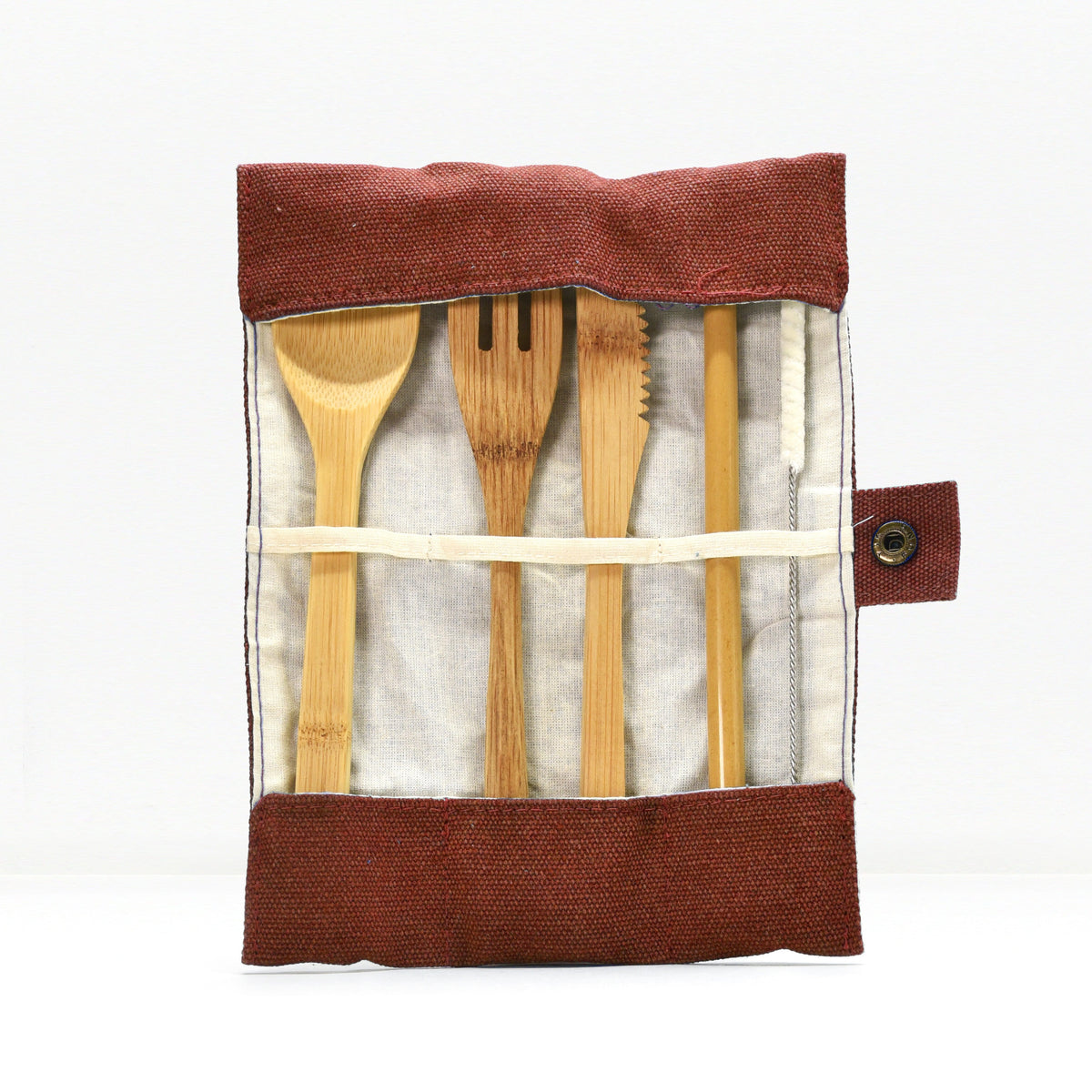 Open teal bamboo cutlery roll revealing spoon fork knife and serrated blade arranged in fabric pockets