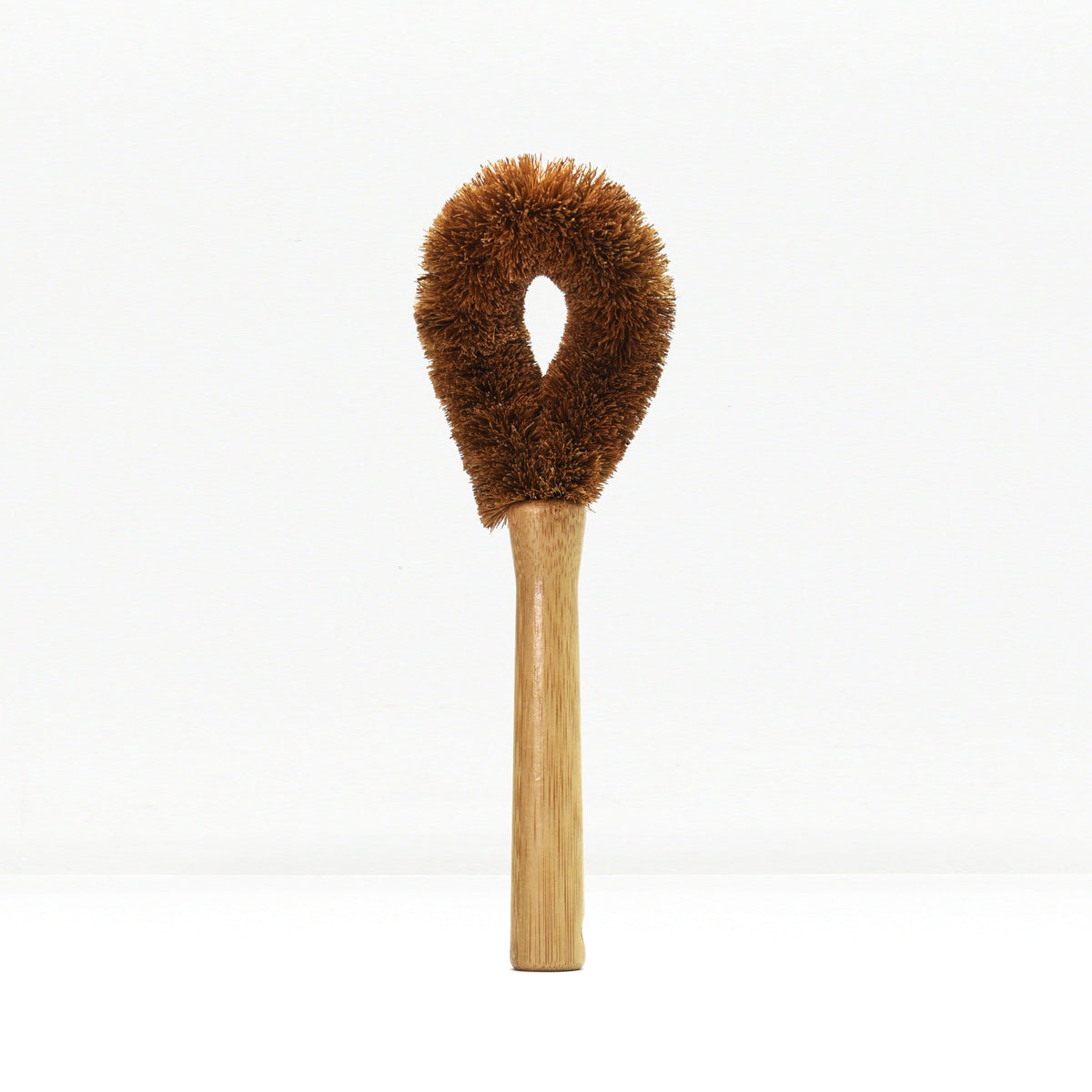Brown fluffy dish brush with wooden handle on a white background