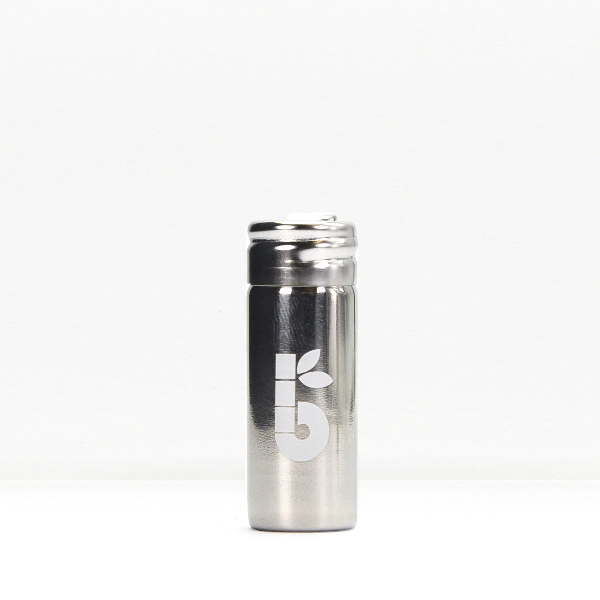 Silk floss product shot showing a small white spool beside a metal container