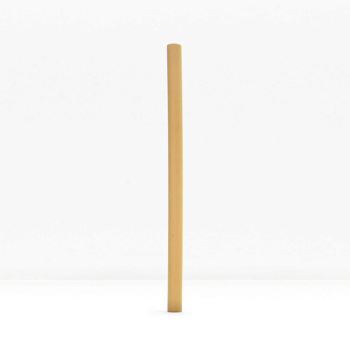 Single bamboo straw centered against a white background