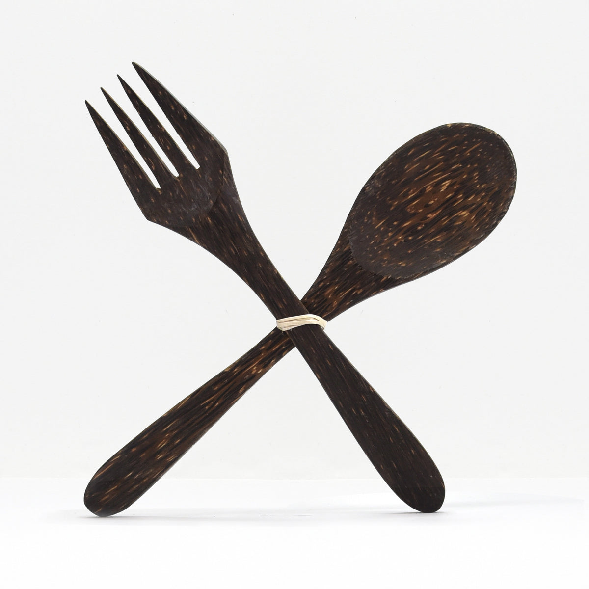 Dark coconut wood fork and spoon tied together with a band
