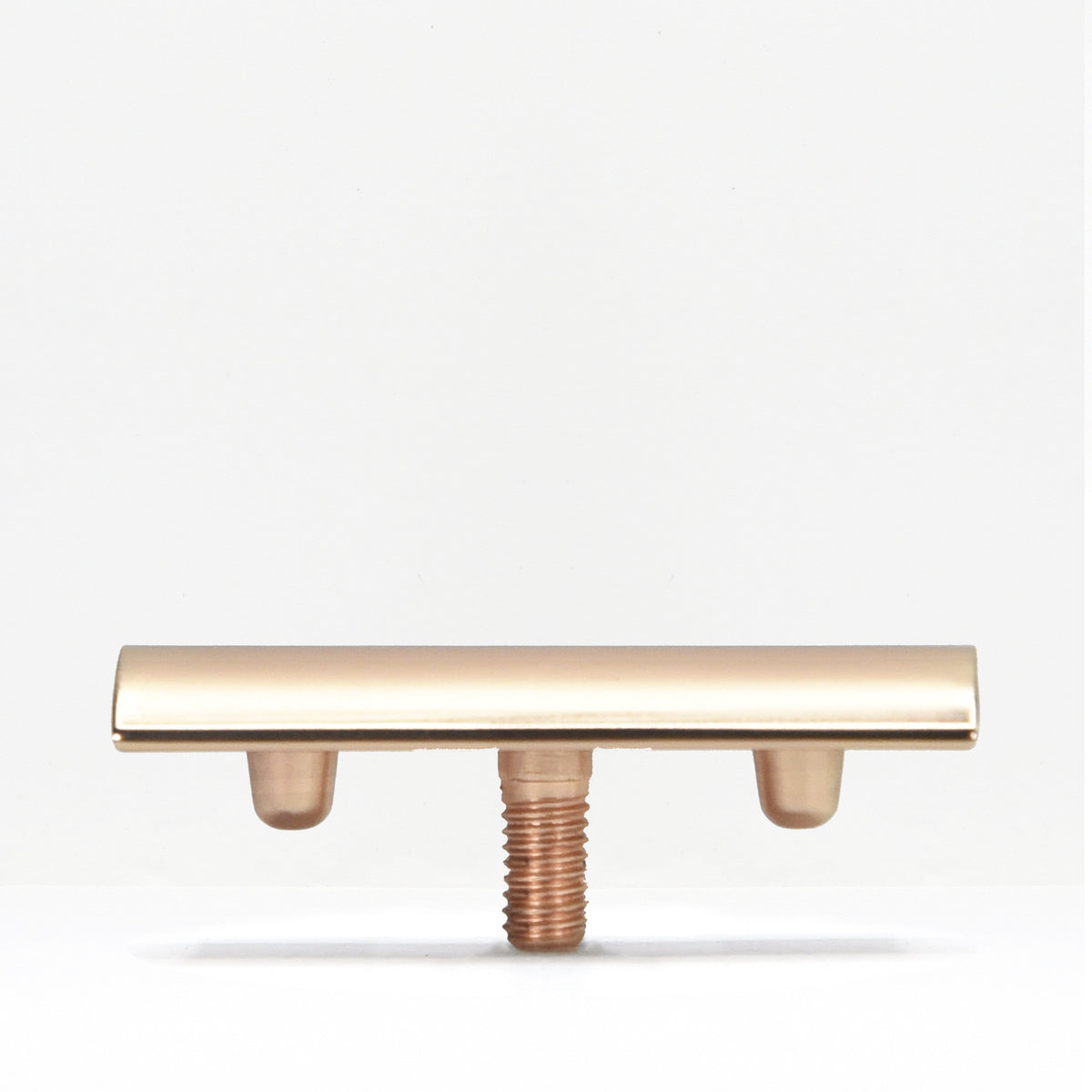 Gold tone safety razor head on a threaded stem against a white background