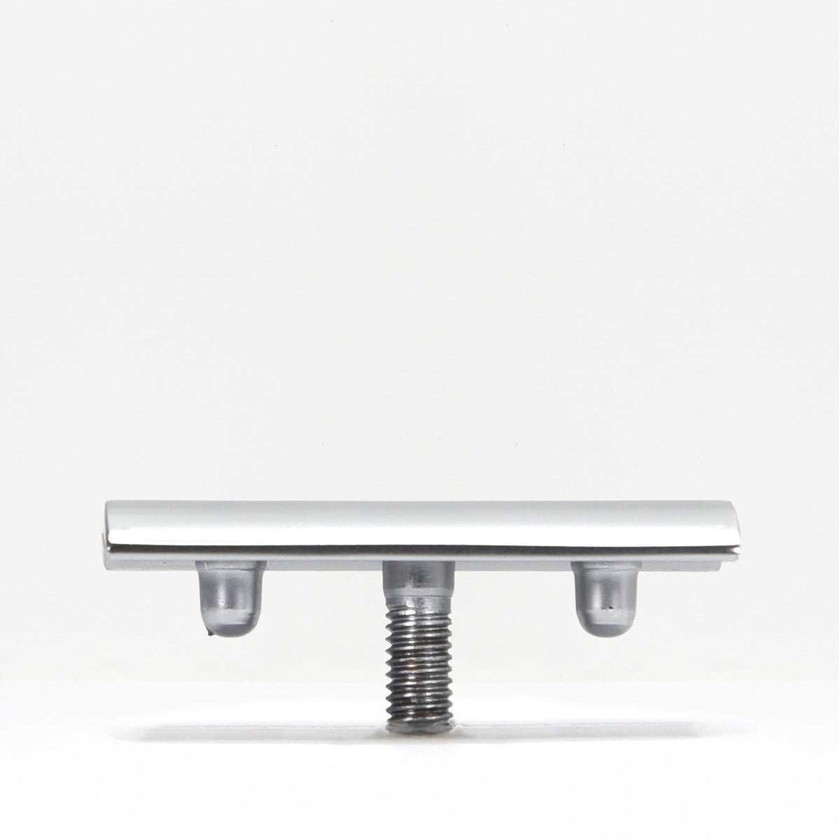Underside view of safety razor head showing mounting posts and threaded connector