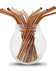 Copper colored metal straws in a glass jar from a bulk pack of 100