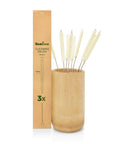 Cotton straw cleaning brushes arranged in a bamboo holder beside the tall cardboard packaging.