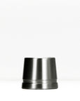 Dark gunmetal safety razor stand on a white surface.