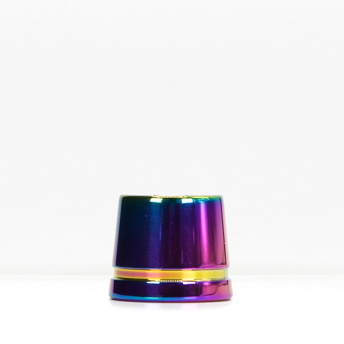 Iridescent metal safety razor stand on a white surface