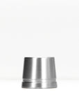 Polished silver metal safety razor stand on a white surface.