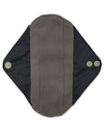 Close up of reusable sanitary pad with gray center and black wings