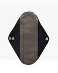 Single reusable panty liner with soft fleece interior and dark outer fabric with snap fasteners