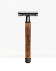 Bamboo safety razor with darker wooden handle and chrome head standing upright on a white background